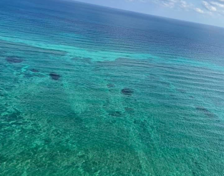 Incredible view of the turquoise ocean waters and horizon from a helicopter in Cancun, Mexico