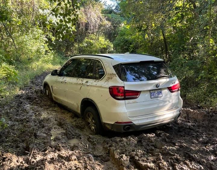 white BMW SUV stuck in the mud in a Palo Verde National Park, Costa Rica