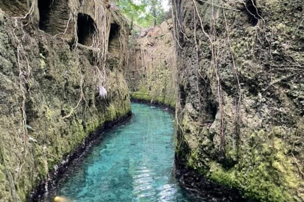 Beautiful stone walled turquoise waters of underground river inside Xcaret theme park in Cancun Mexico