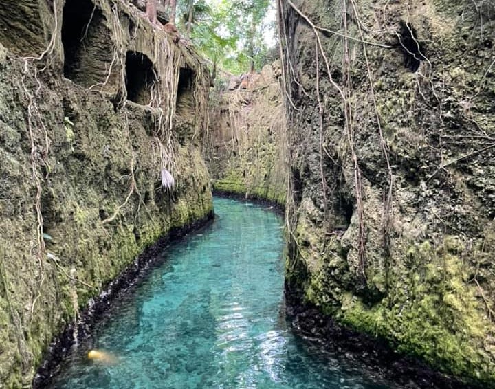 Beautiful stone walled turquoise waters of underground river inside Xcaret theme park in Cancun Mexico