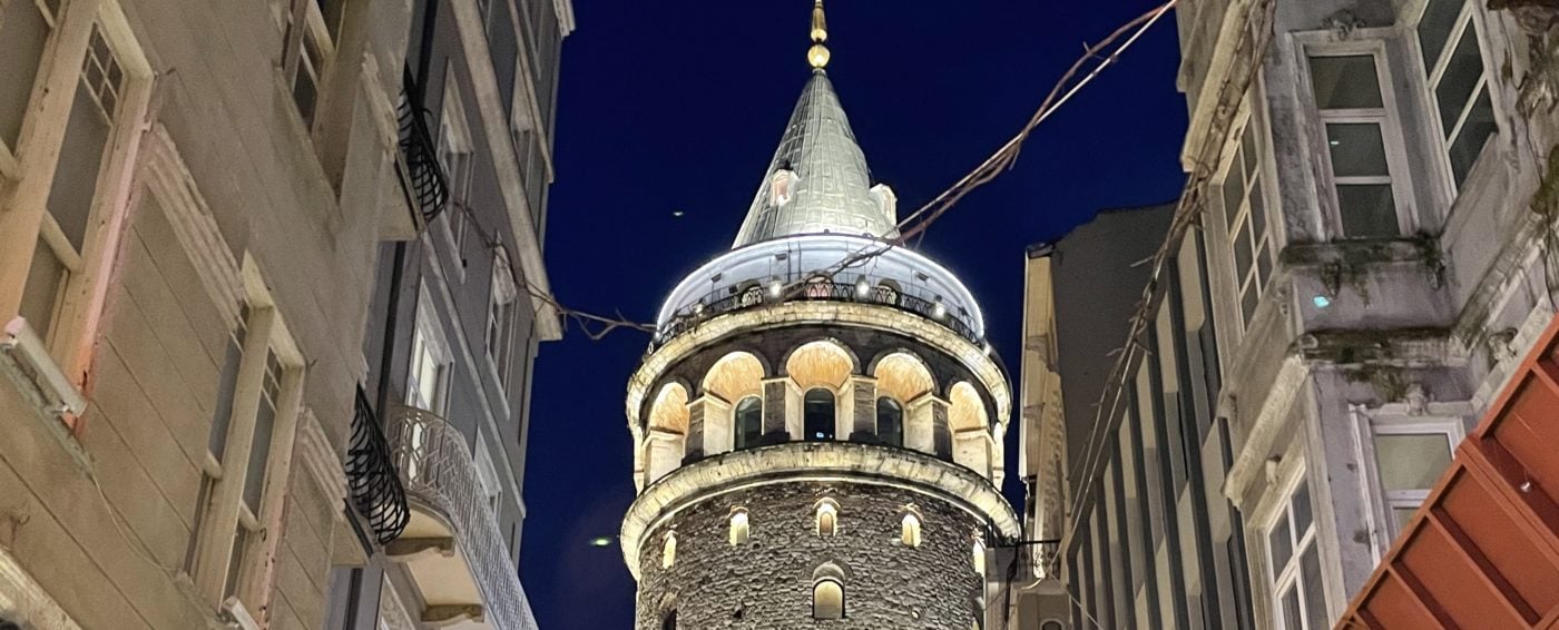 Amazing close up ground view of the illuminated Galata Tower at night in Istanbul, Turkey