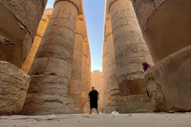 Standing in between the huge columns in the Temple of Karnak in Luxor