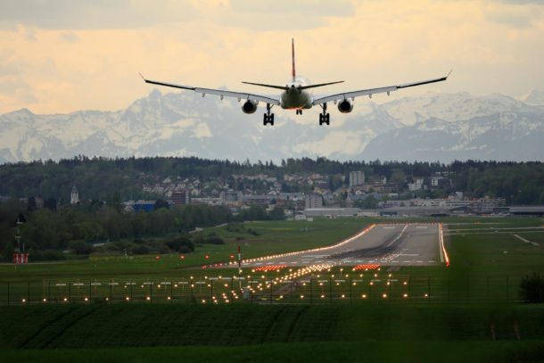 airplane landing with scenic background