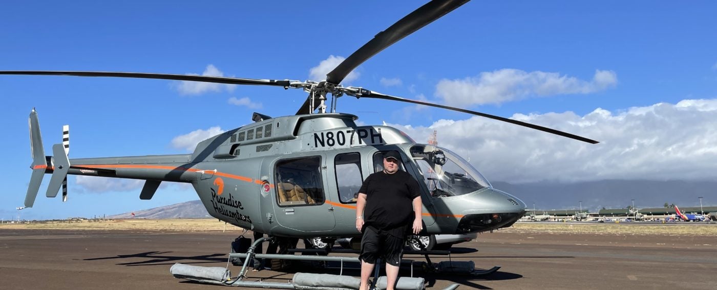 Mark standing in front of a helicopter in Hawaii