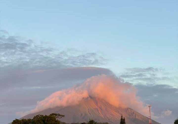 Distant view of smoking Masaya Volcano with a beautiful sky behind it in Nicaragua