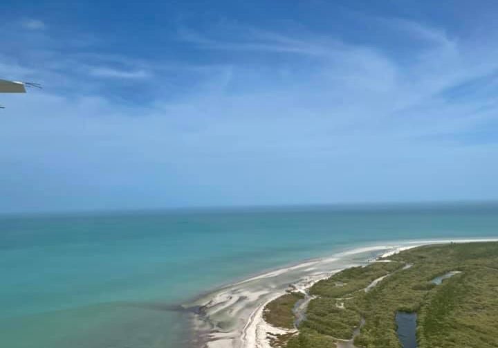 View of the coast of Cancun, Mexico from a prop plane
