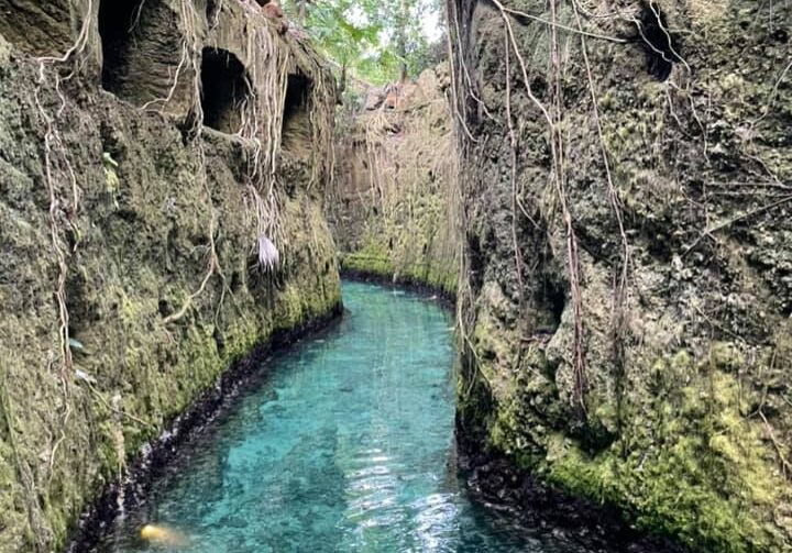 Beautiful stone walled turquoise waters of underground river inside Xcaret theme park in Cancun Mexico